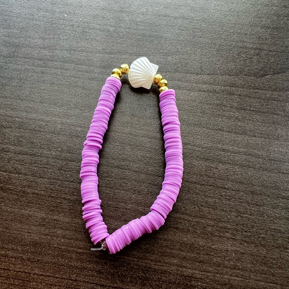 Purple clay beaded bracelet with gold accent and shell accent
